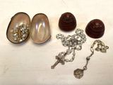 a small box with beads and a rosary on a table