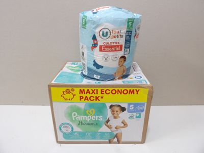 two boxes of diapers sitting on top of each other on a table