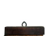 an old wooden box sitting on top of a white surface