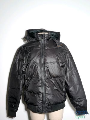 jacket on mannequin dummy in front of a white wall