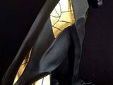 statue of a black cat with gold accents on a black base