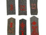 six small tags with numbers and symbols on them on a white surface