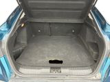 a trunk of a blue car with its trunk open