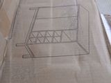 a cardboard box with a drawing of a chair on it