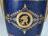a blue and gold vase with a monkey on it