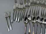 a lot of spoons and forks on the table
