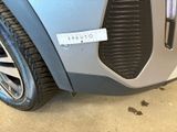 a close up of a car ' s grille with a sticker on it