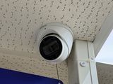 a security camera attached to the ceiling of a building