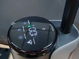 a coffee maker that is sitting on a table next to a laptop