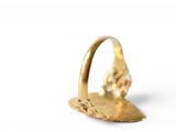 a gold ring with a diamond on it