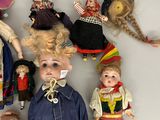 a lot of dolls that are sitting on a table