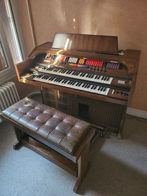 a piano and a bench in the corner of a room