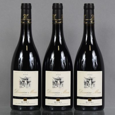 three bottles of wine are lined up on a table