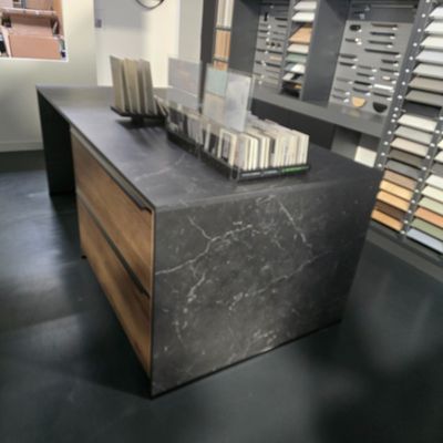 a marble counter top with a wooden drawer in the middle of it