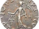 a close up of a silver coin with a woman holding a branch