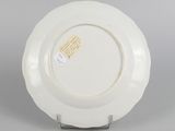 underside view of a white plate with a yellow label on it