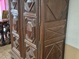 a large wooden cabinet in the corner of a room