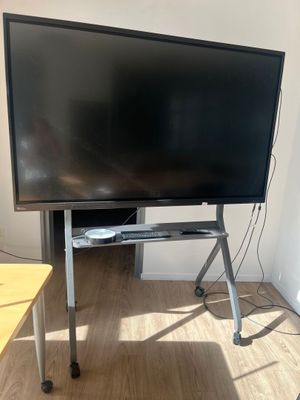 a flat screen tv sitting on a stand in a room