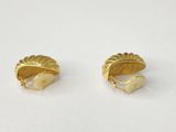 a pair of gold plated earrings on a white surface