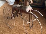 a toy horse that is sitting on top of a bicycle