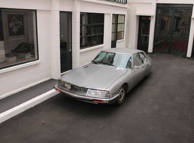 a silver car parked in front of a building