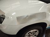 a white truck that has been painted white in a garage