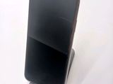 a cell phone that is on a stand on a table