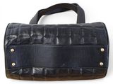a black leather purse with gold hardwares on a white background