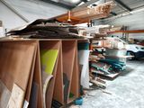 a large amount of wood in a warehouse with many different types of wood