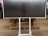 a large flat screen tv on a stand in a warehouse