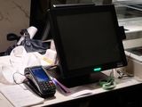a cell phone sitting on top of a desk next to a computer monitor