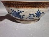 a blue and white bowl sitting on a table
