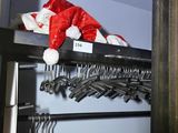 a rack with clothes and a santa hat on top of it