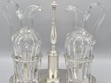 a silver plate with three glass vases on it