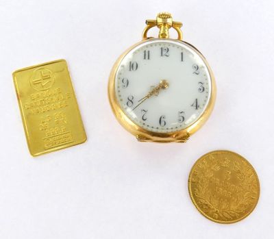 a gold bar next to a pocket watch and a gold bar