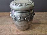 an image of a silver vase sitting on top of a wooden table