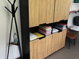 a wooden cabinet and a shelf in the corner of a room