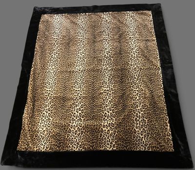 a leopard print blanket on a grey background
