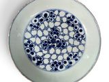 a blue and white plate with a design on it