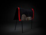 a black and red chair with a blanket on top of it