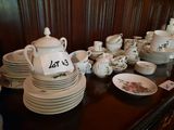 many plates and cups on the table with a price tag