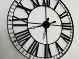 a large clock on the wall with roman numerals on it