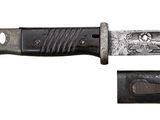 a knife that is sitting on top of a piece of metal