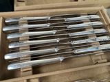 a lot of silverware in a box with a pair of scissors