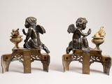 pair of bronze figurines of cherensils and a bird on a table