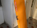 an orange atm machine in the corner of a room