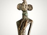 an image of a statue of a woman with a hat on her head