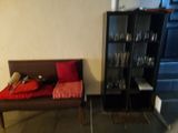 a couch and a chair in a room with a bookcase