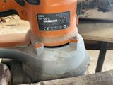 a sander that is sitting on a piece of wood