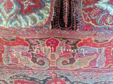 a close up of a rug with a cat on it